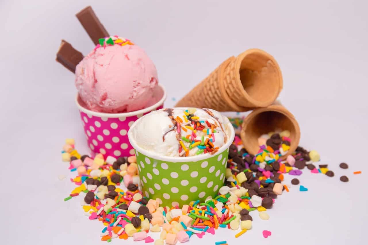 Several different ice cream cups and cones