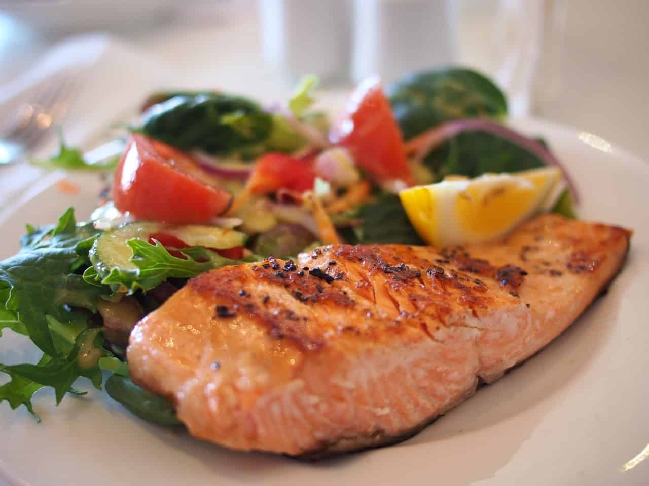 A plate of salmon and vegetables